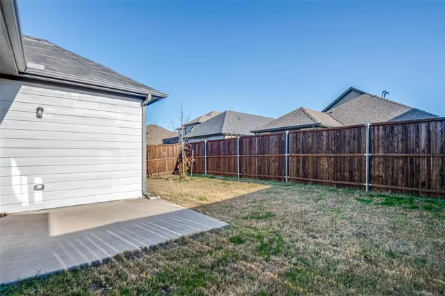 a view of a house with wooden fence