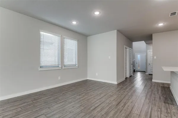 a view of a room with wooden floor and window