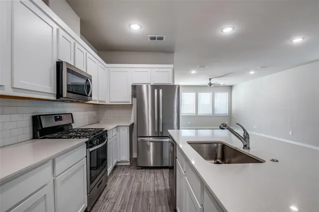 a kitchen filled a sink a microwave a stove and refrigerator