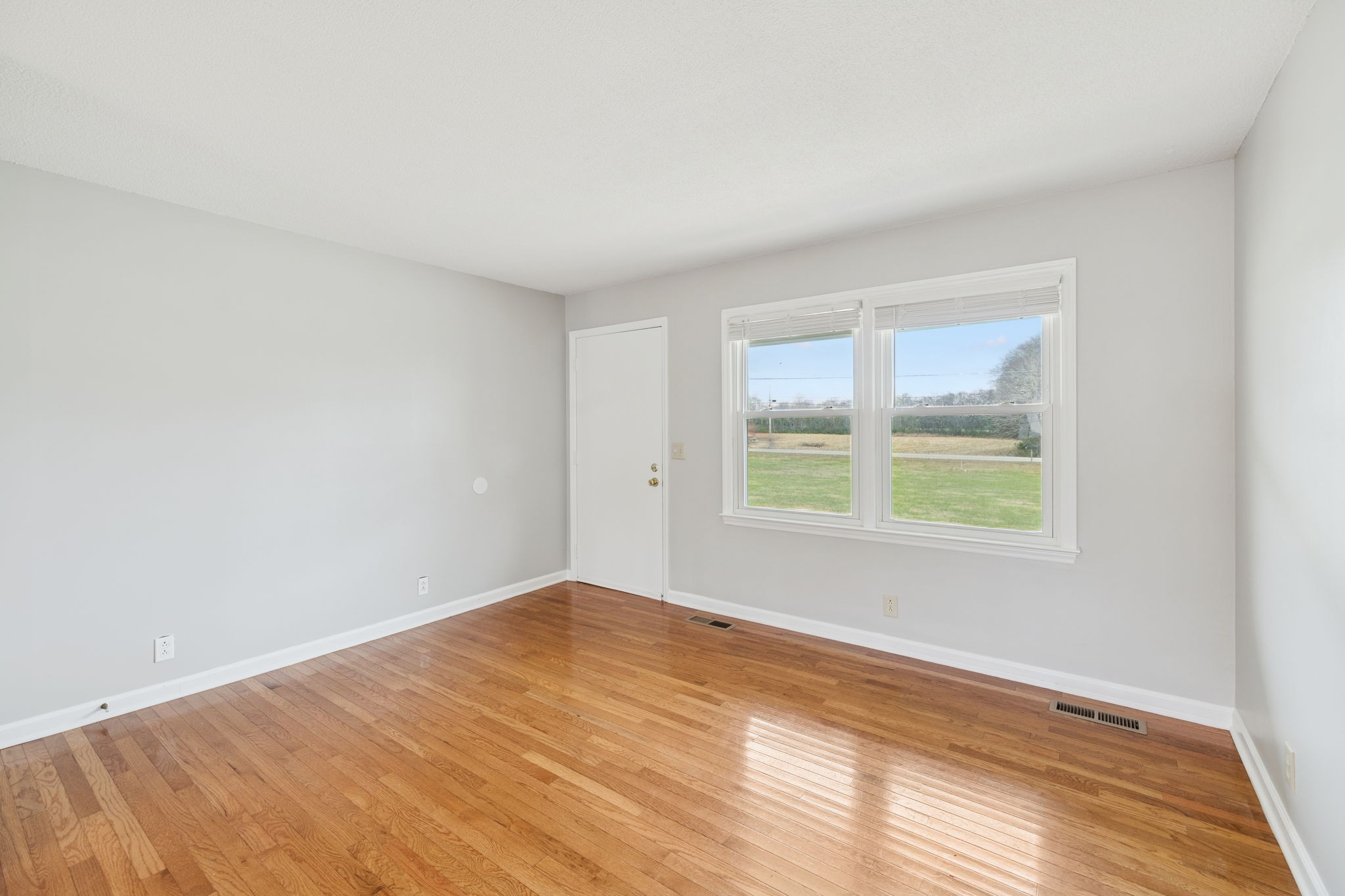 2053 West Jefferson Pike Murfreesboro, TN 37129 - Photo 29 of 86 an empty room with wooden floor and windows