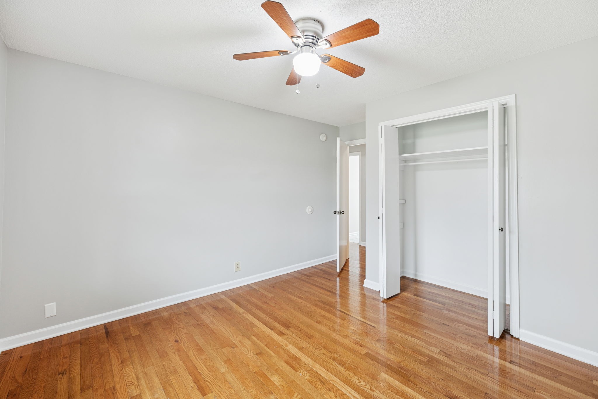 2053 West Jefferson Pike Murfreesboro, TN 37129 - Photo 37 of 86 an empty room with wooden floor and a ceiling fan