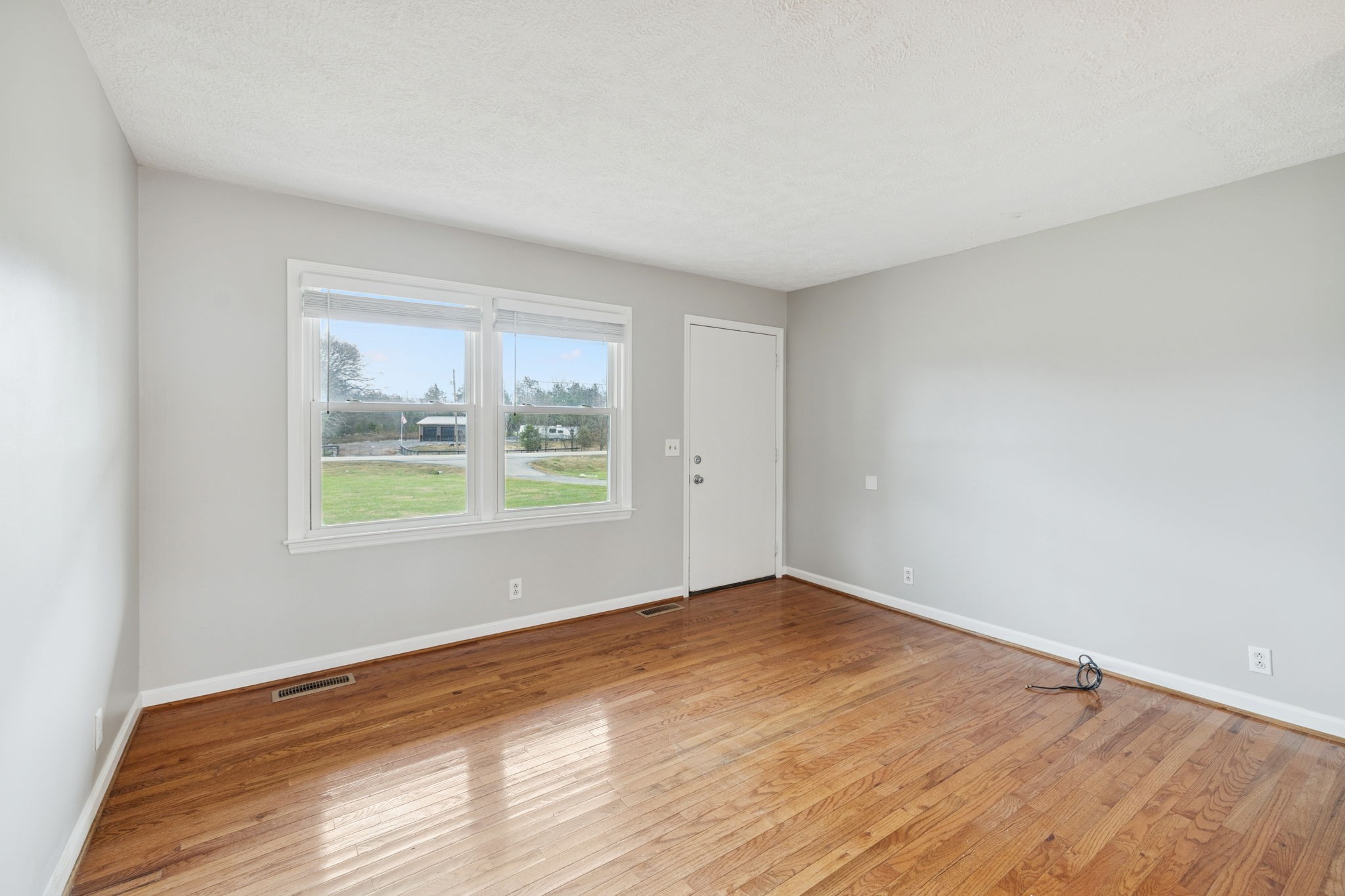 2053 West Jefferson Pike Murfreesboro, TN 37129 - Photo 72 of 86 a view of an empty room with wooden floor and a window