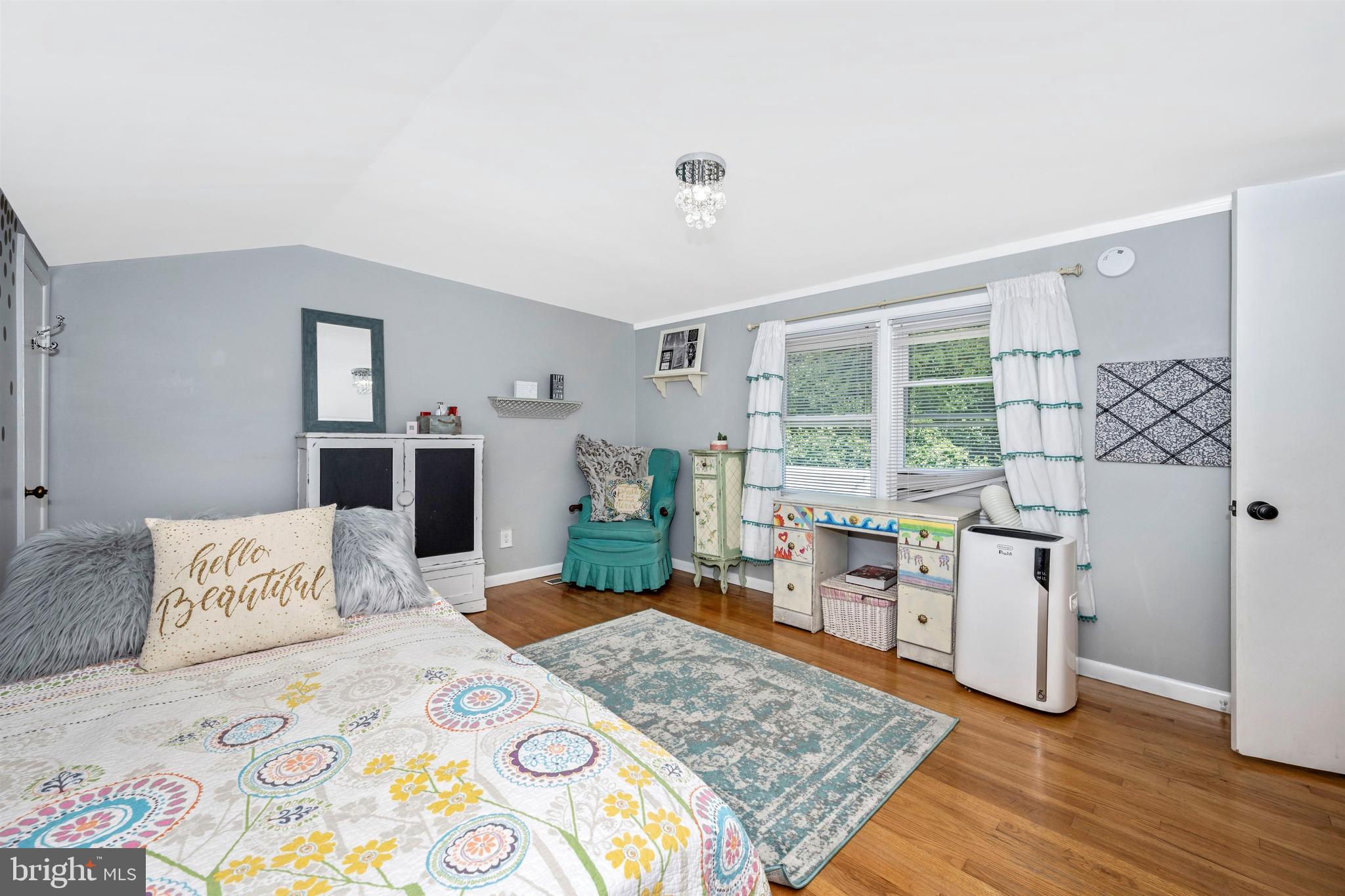 4304 Ridge Avenue Baltimore, MD 21227 - Photo 23 of 50 a bedroom with a bed and wooden floor