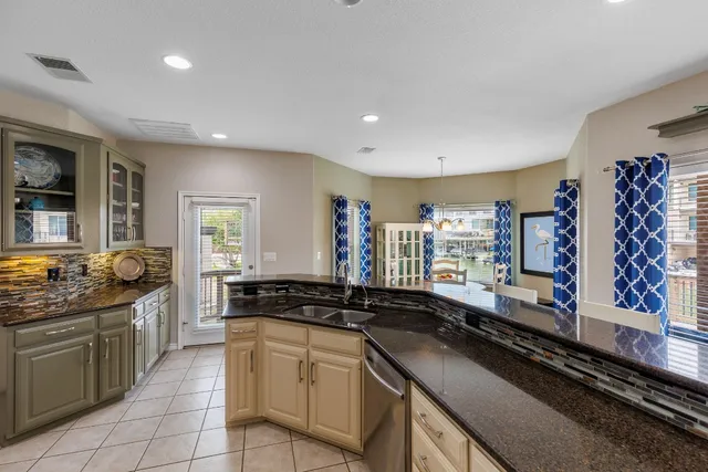 a kitchen with stainless steel appliances granite countertop counter space a sink refrigerator and cabinets