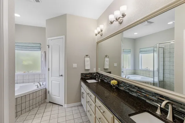 a bathroom with a granite countertop sink a toilet and a mirror