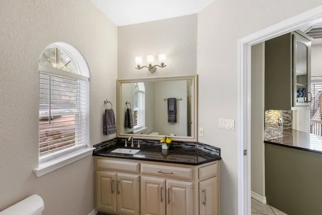 a view of residential houses with swimming pool and wooden fence
