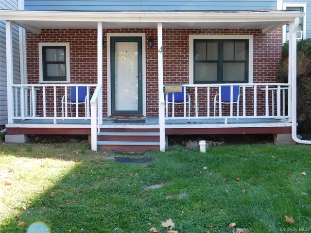 a view of a house with a yard and deck