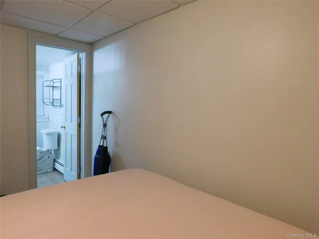 a bedroom with a bed and a mirror