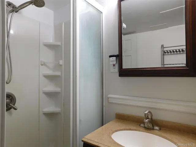 a bathroom with a sink toilet and mirror