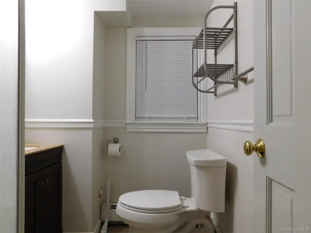 a bathroom with a toilet and a shower curtain