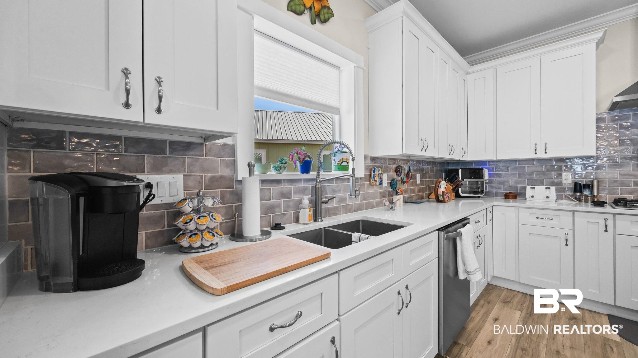 8013 Carmel Circle Foley, AL 36535 - Photo 12 of 49 Kitchen with white cabinetry, light wood-style floors, tasteful backsplash, light stone counters, and dishwasher