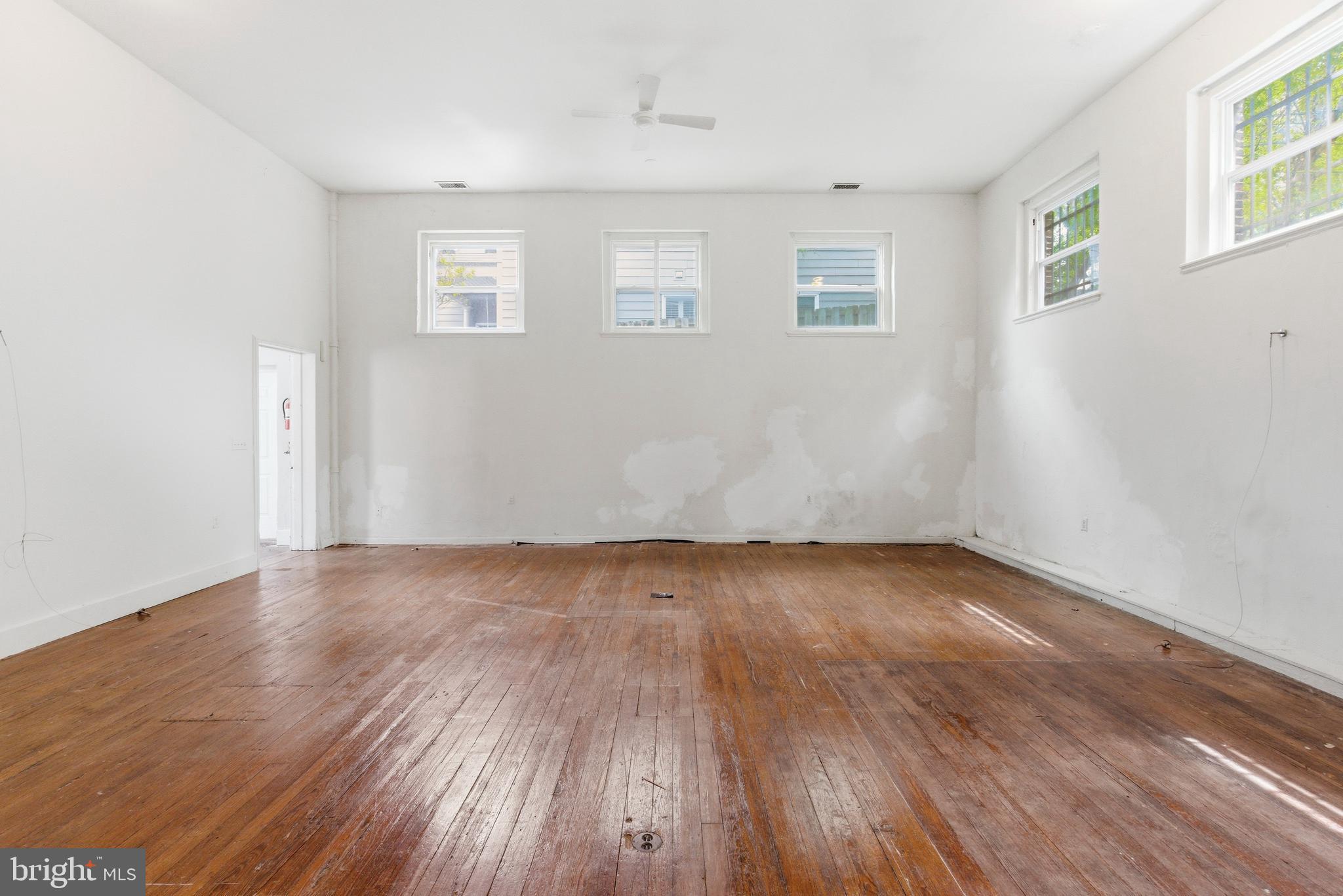 1401 Light Street Baltimore, MD 21230 - Photo 16 of 39 an empty room with wooden floor and windows