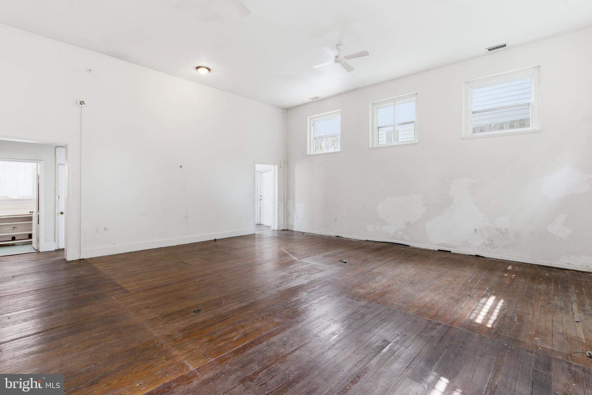 1401 Light Street Baltimore, MD 21230 - Photo 17 of 39 an empty room with wooden floor and windows