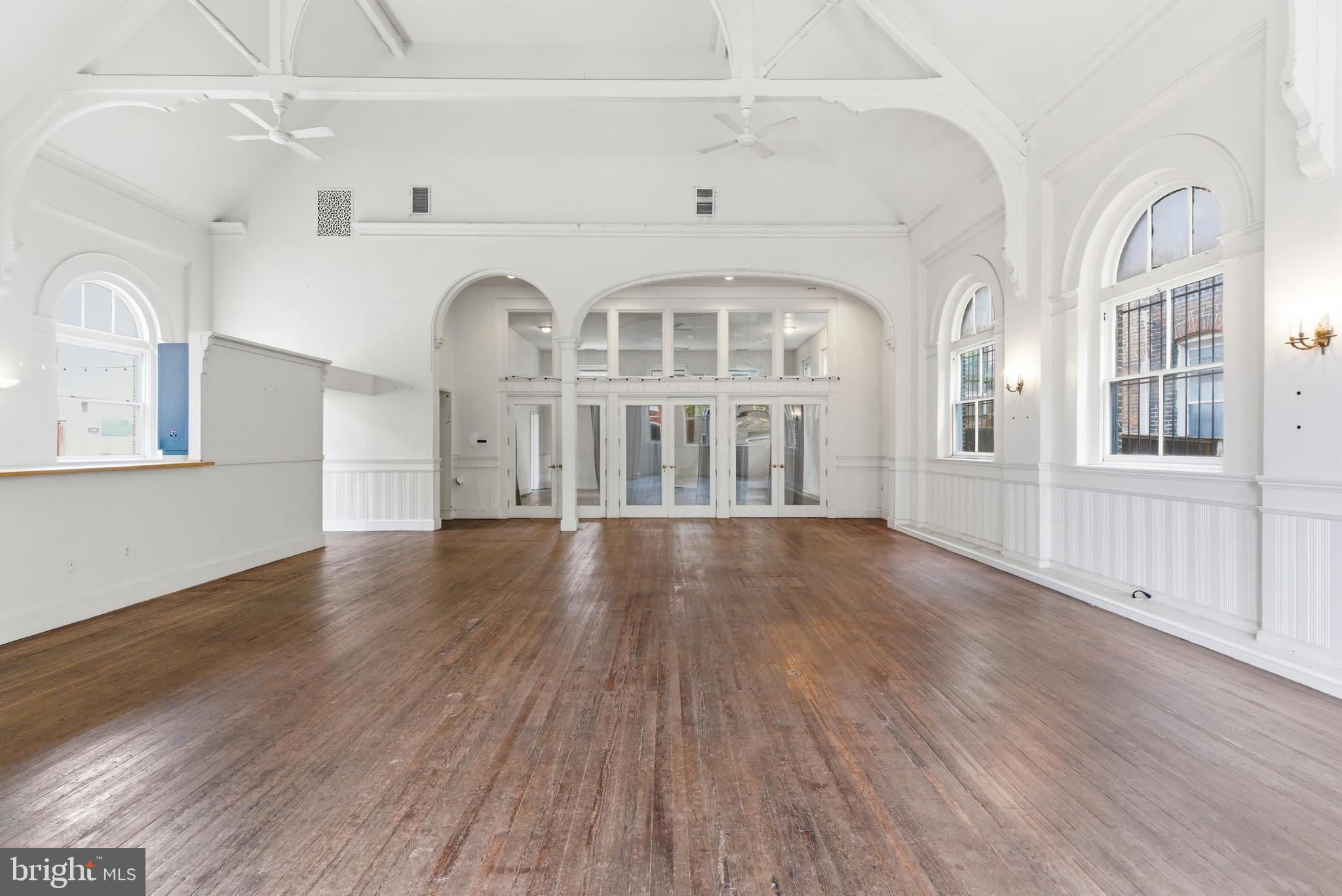 1401 Light Street Baltimore, MD 21230 - Photo 3 of 39 a view of an empty room with wooden floor and a window