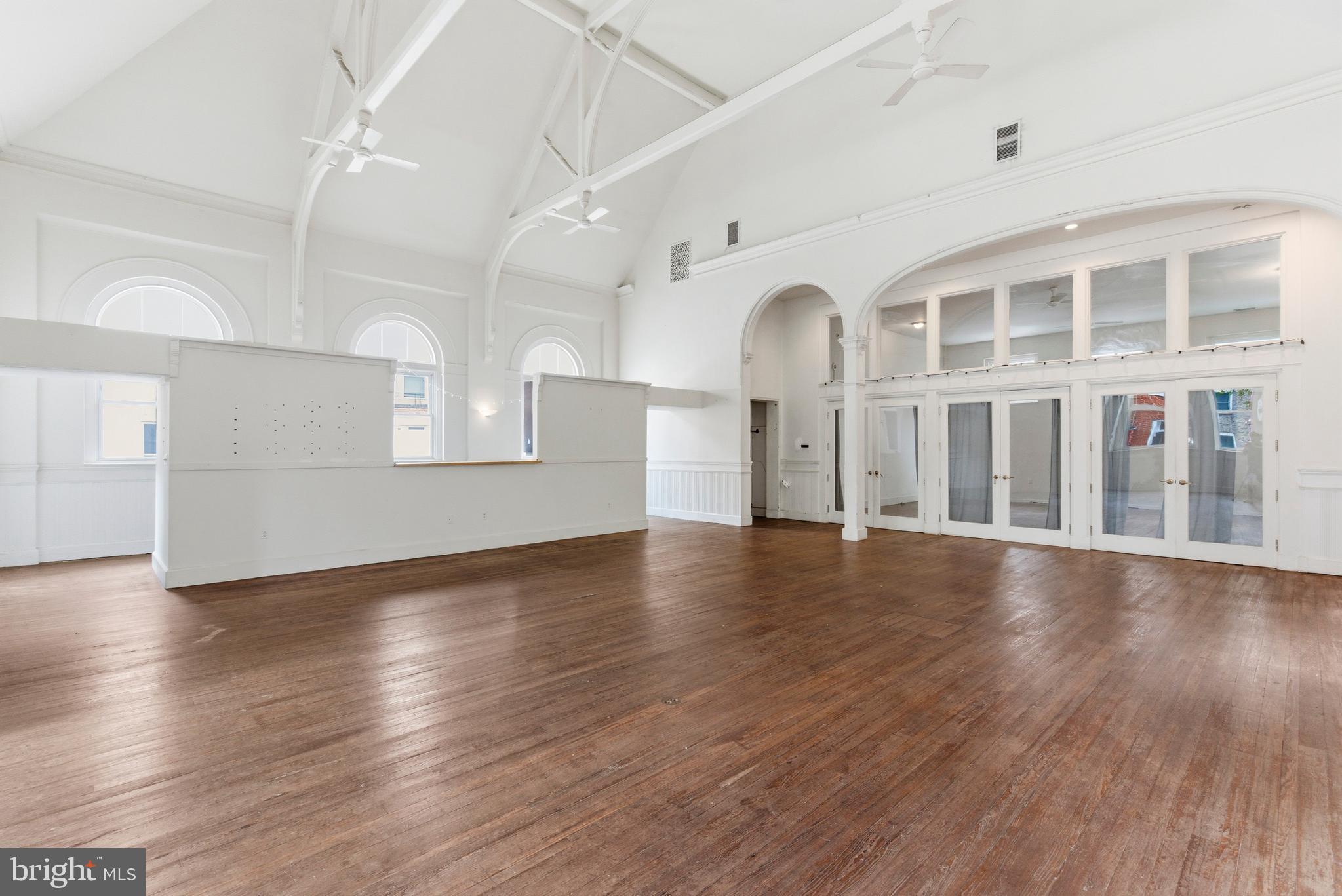 1401 Light Street Baltimore, MD 21230 - Photo 5 of 39 a view of an empty room with wooden floor and a window