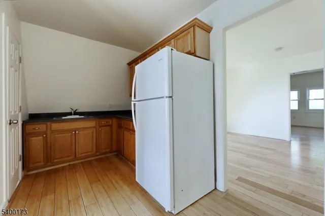 a view of walk in closet with wooden floor