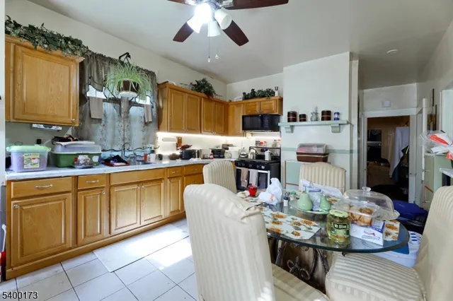 a kitchen with stainless steel appliances kitchen island granite countertop a refrigerator a stove top oven a sink and dishwasher
