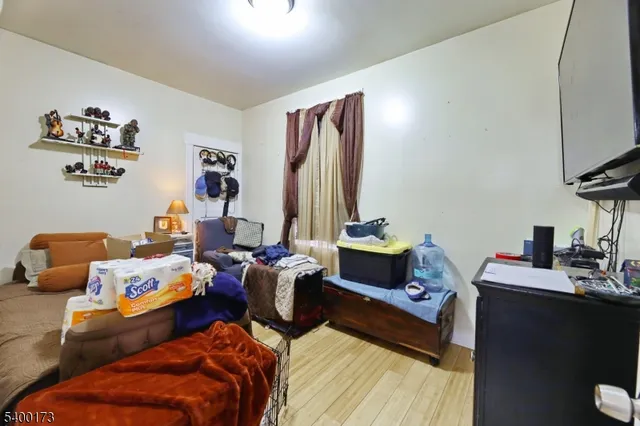 a bed room with two bed and a flat screen tv