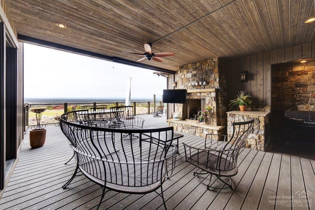 16163 South W Brasada Ranch Road Powell Butte, OR 97753 - Photo 21 of 24 a view of a roof deck with table and chairs barbeque oven with wooden floor