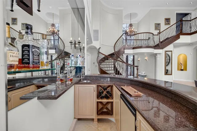 a kitchen with granite countertop a sink a counter top space and living room view