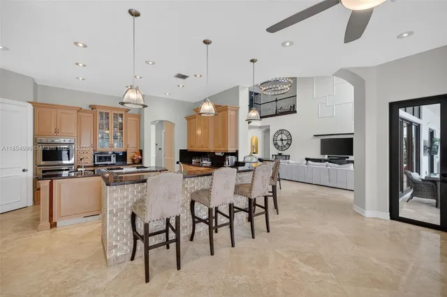 a kitchen with stainless steel appliances granite countertop a sink a stove and a refrigerator