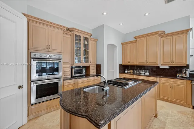a kitchen with stainless steel appliances granite countertop a stove and a refrigerator