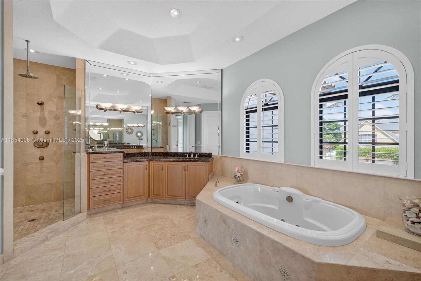2649 Northeast 26th Avenue Lighthouse Point, FL 33064 - Photo 29 of 60 a bathroom with a tub sink and mirror