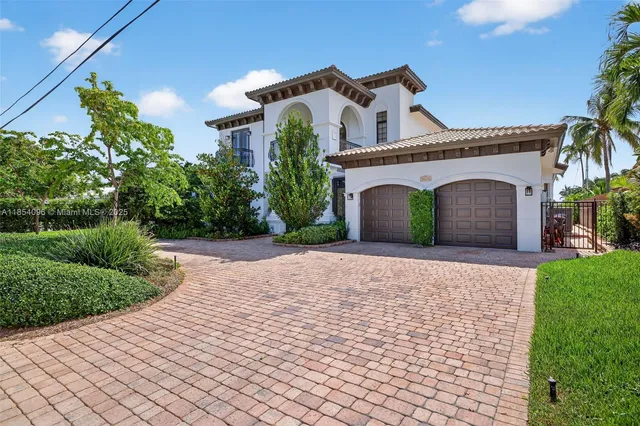 a front view of a house with a yard and a garage