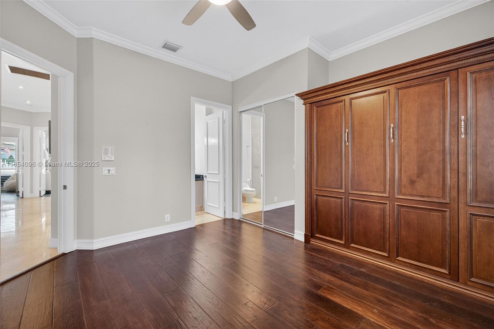 2649 Northeast 26th Avenue Lighthouse Point, FL 33064 - Photo 39 of 60 an empty room with wooden floor cabinet and windows
