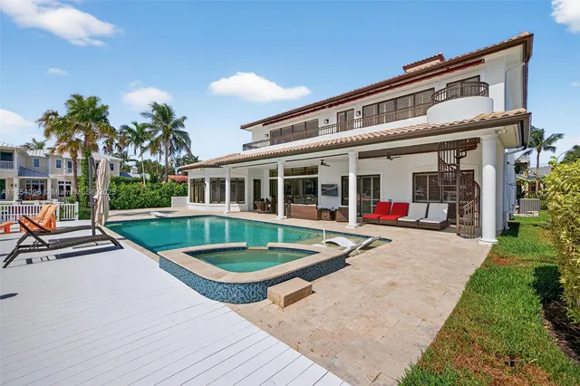 a view of house with outdoor space and swimming pool