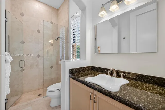 a living room with patio furniture and a floor to ceiling window