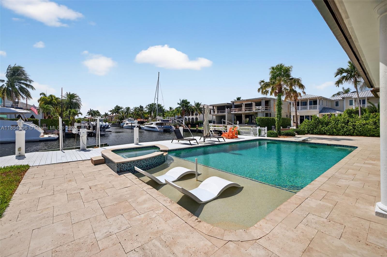 2649 Northeast 26th Avenue Lighthouse Point, FL 33064 - Photo 55 of 60 a view of a swimming pool and lounge chairs