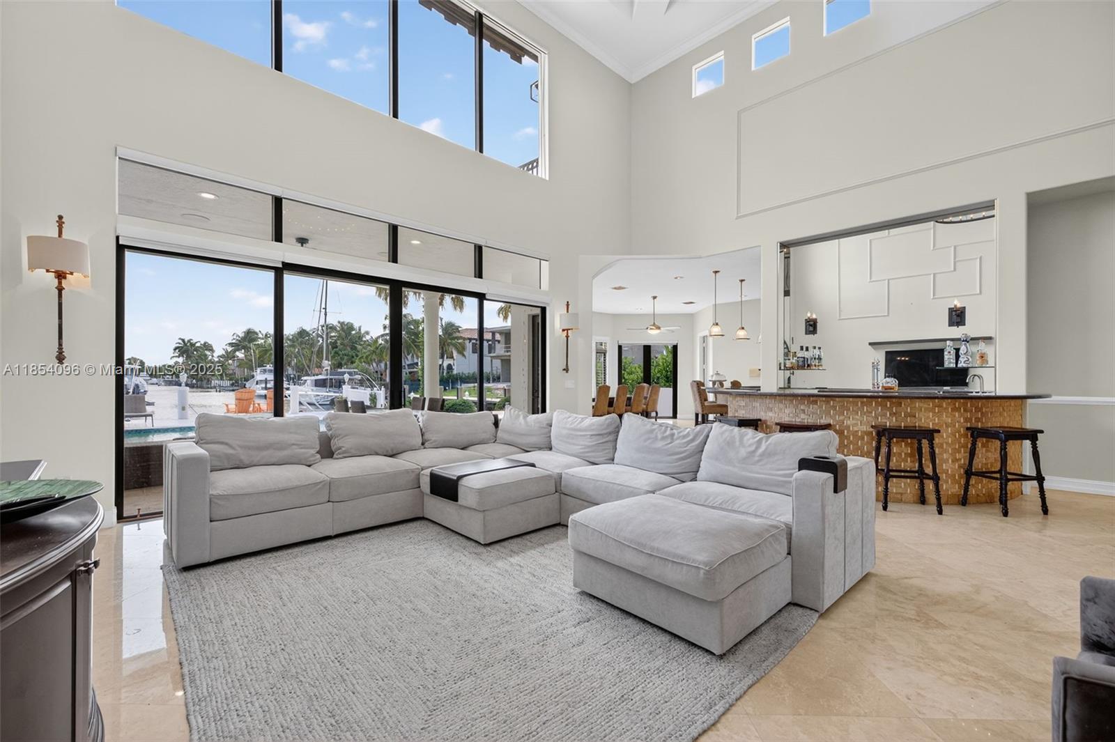 2649 Northeast 26th Avenue Lighthouse Point, FL 33064 - Photo 9 of 60 a living room with furniture and a large window