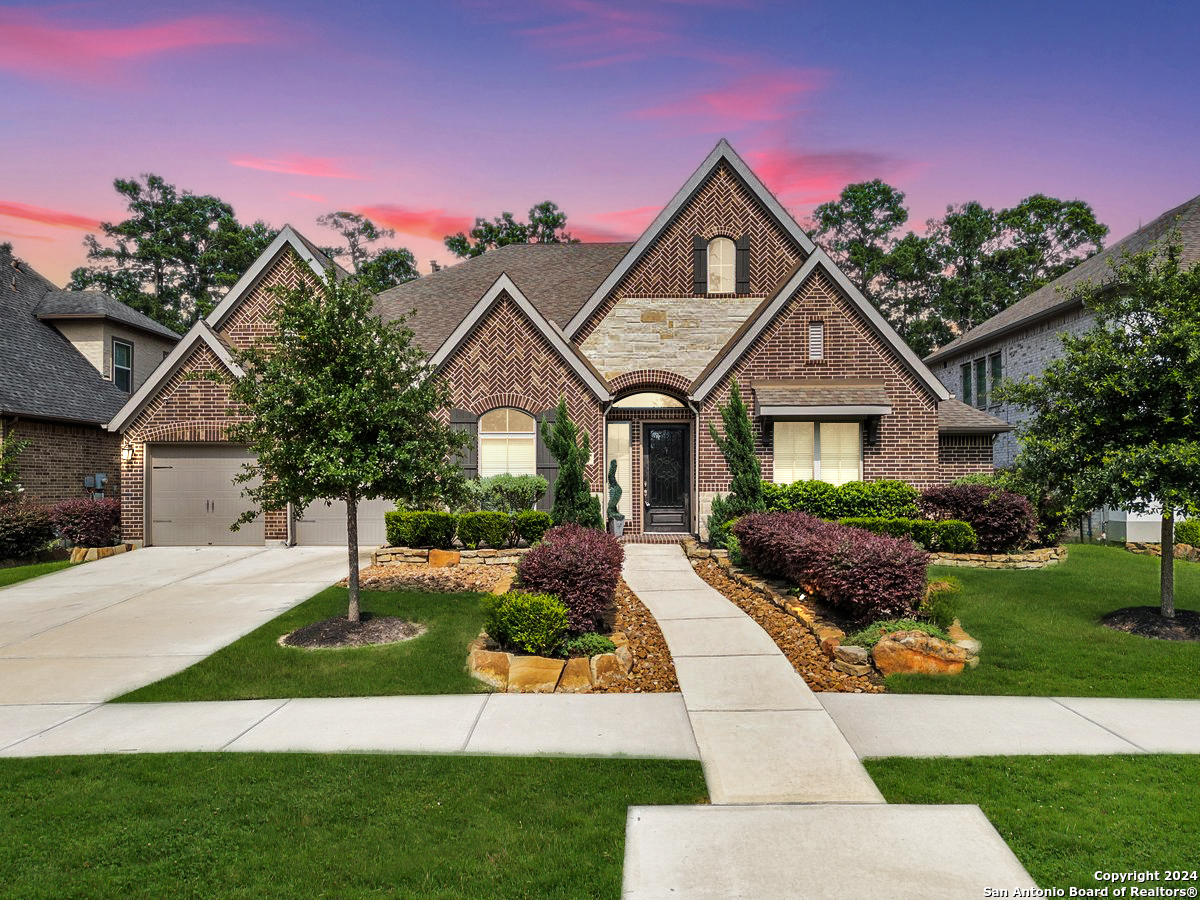 17306 Sages Ravine Drive Humble, TX 77346 - Photo 1 of 1 a front view of a house with a yard and potted plants