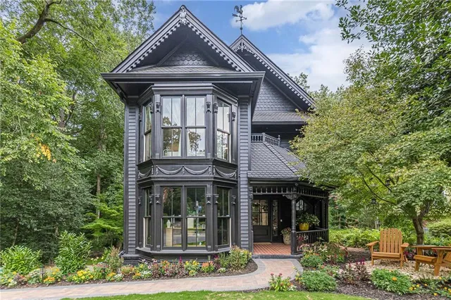 a view of a chairs and table in backyard of the house