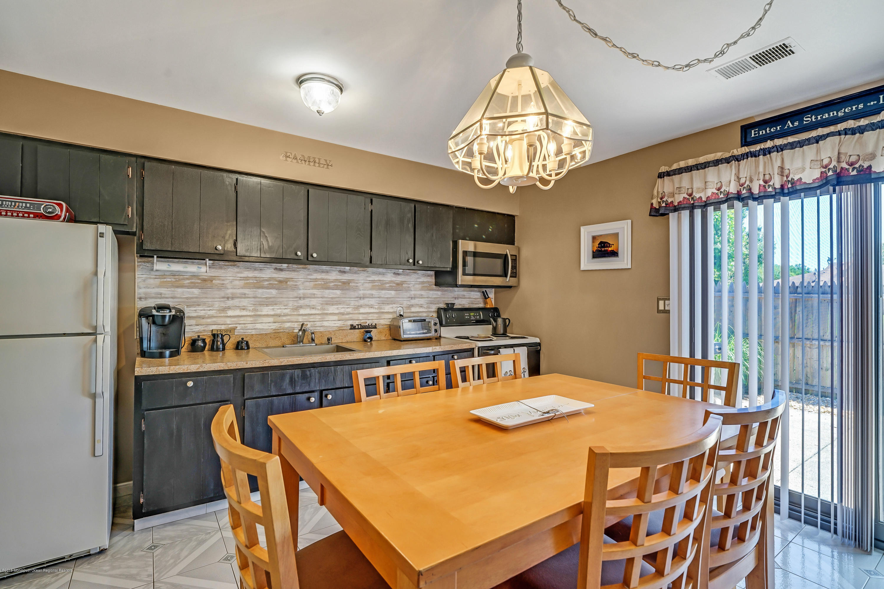 118 Greenwood Loop Road Brick, NJ 08724 - Photo 12 of 18 a kitchen with stainless steel appliances granite countertop a sink a stove a refrigerator a dining table and chairs