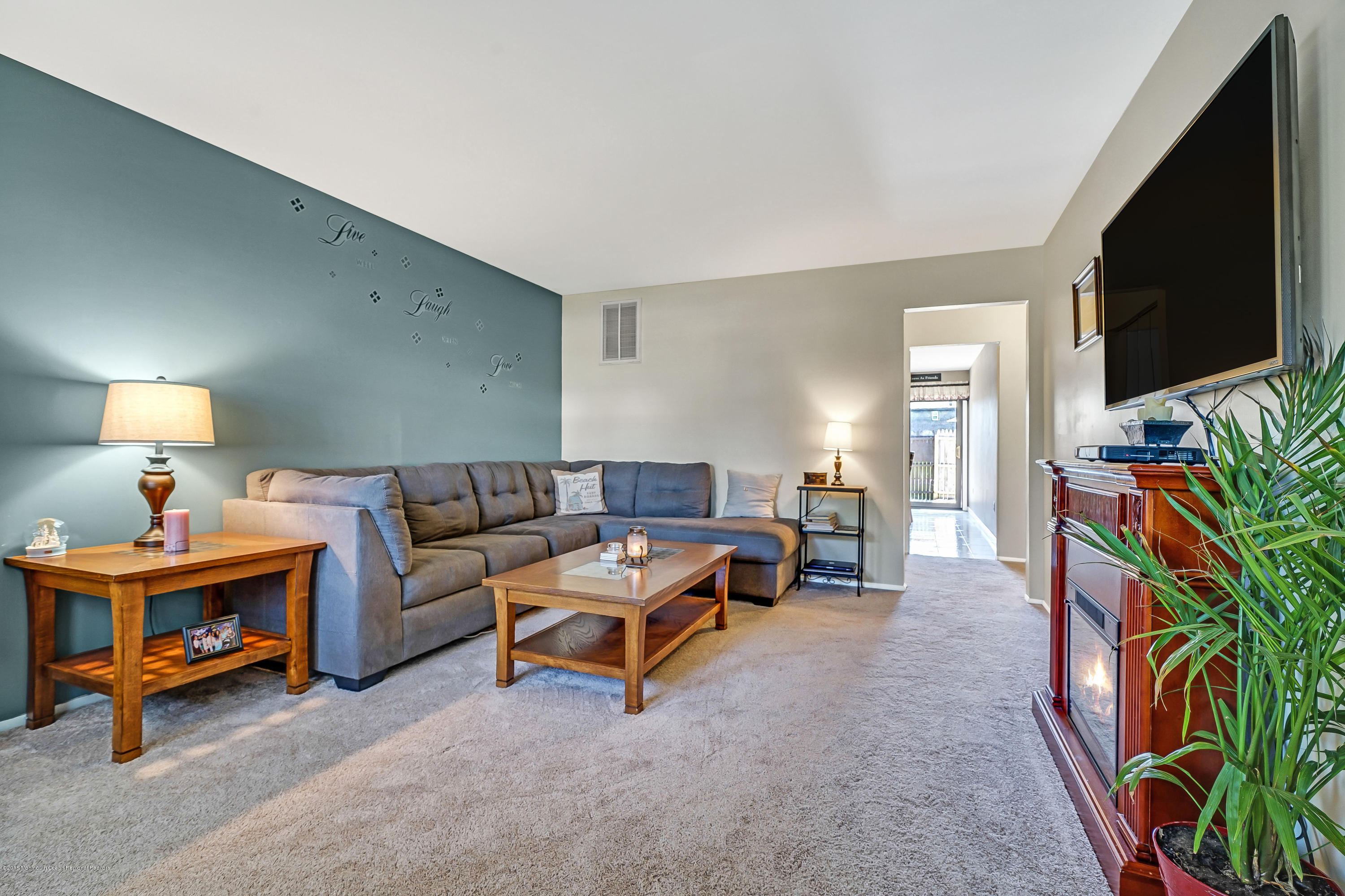 118 Greenwood Loop Road Brick, NJ 08724 - Photo 4 of 18 a living room with furniture and a flat screen tv