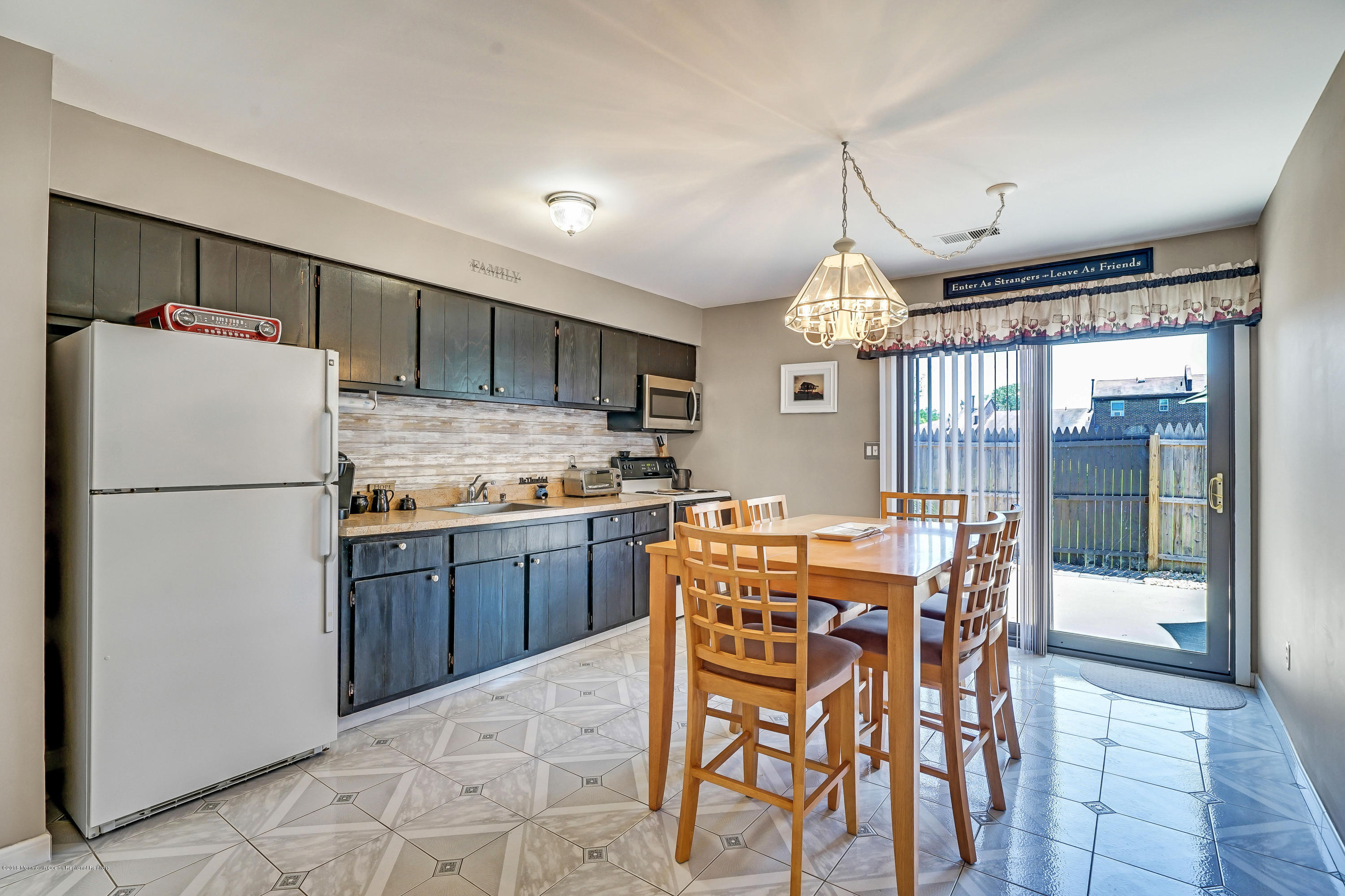 118 Greenwood Loop Road Brick, NJ 08724 - Photo 7 of 18 a kitchen with stainless steel appliances granite countertop a refrigerator a sink dishwasher a dining table and chairs with wooden floor
