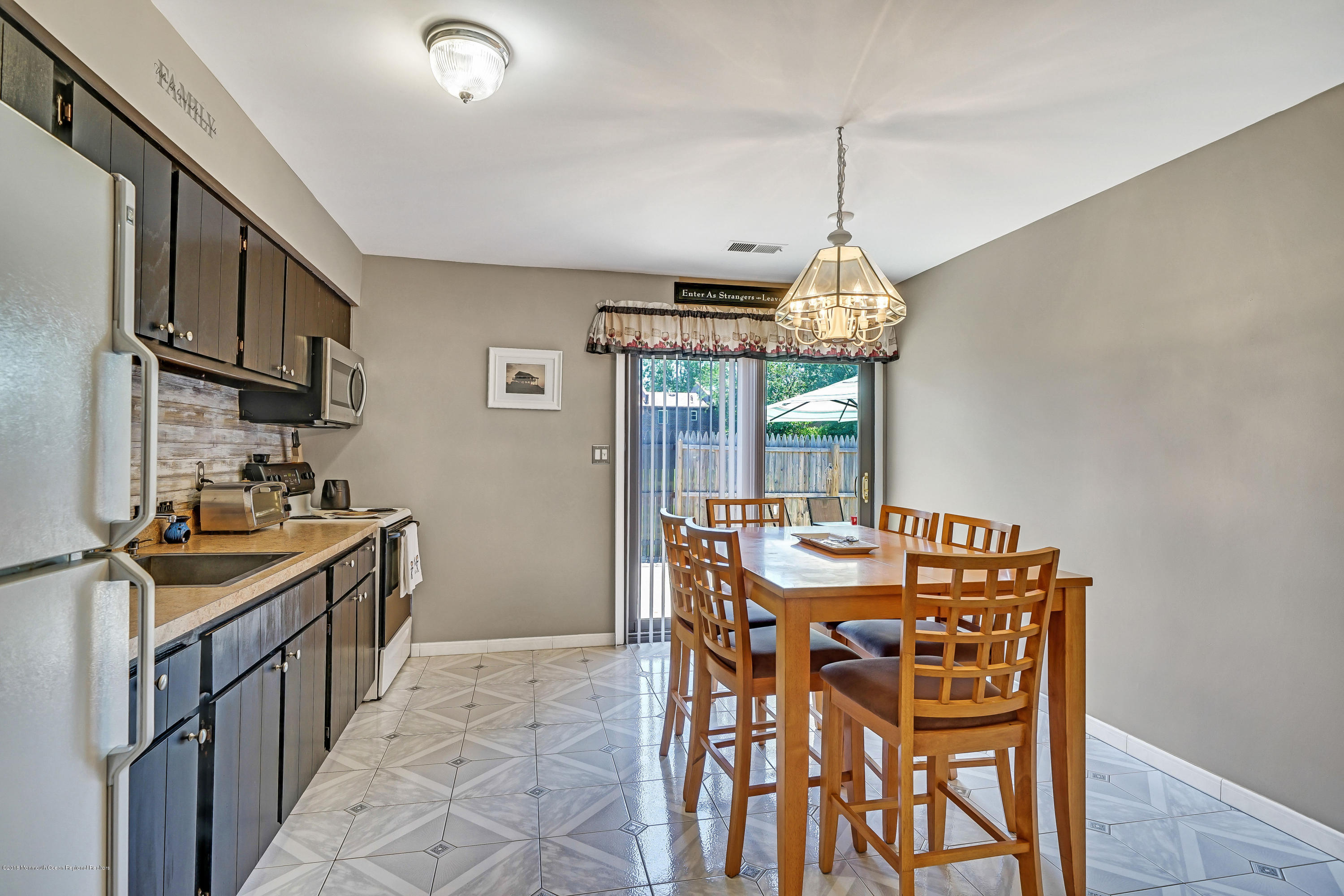 118 Greenwood Loop Road Brick, NJ 08724 - Photo 8 of 18 a kitchen that has a table and chairs in it