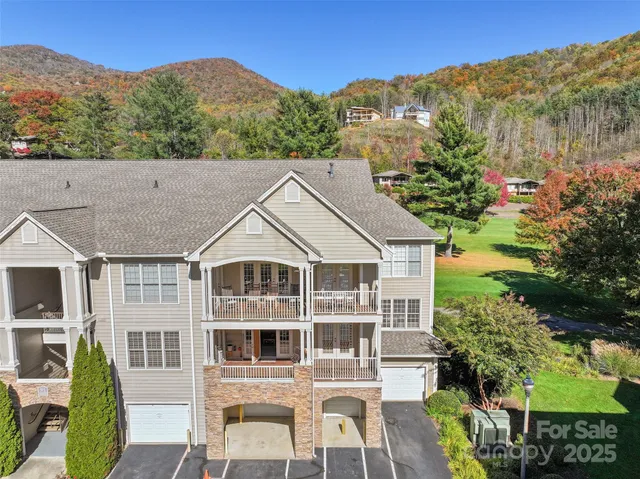 a aerial view of a house with a yard and balcony