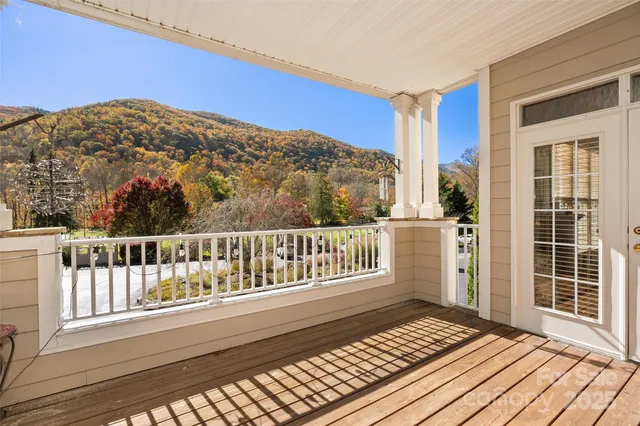 a view of a balcony with wooden floor and fence