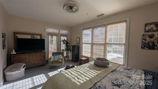 a bedroom with a bed and glass door
