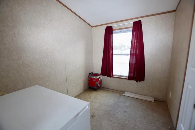 a room with a window and bed