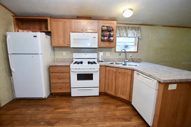 a kitchen with a stove a refrigerator and a sink