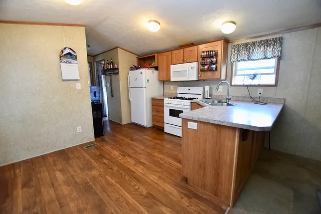 a kitchen with stainless steel appliances a refrigerator sink and microwave