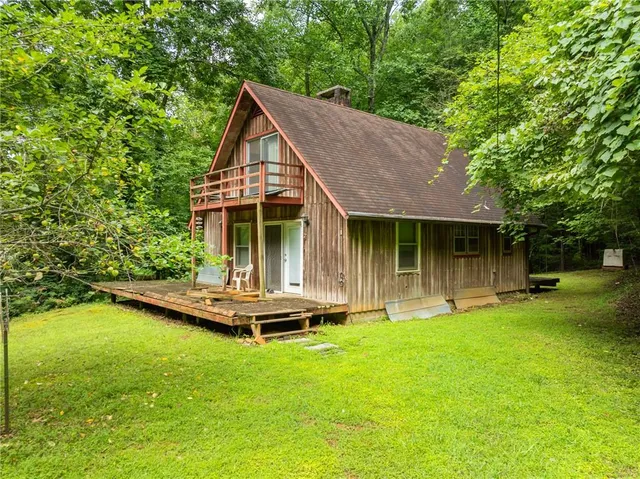 a front view of a house with a yard table and chairs