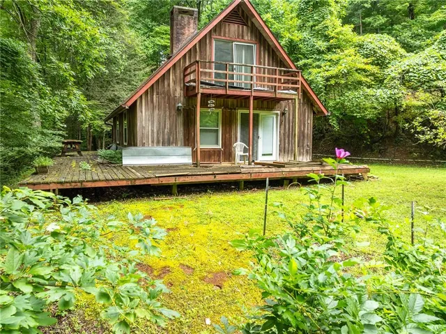 a view of a house with pool and sitting area