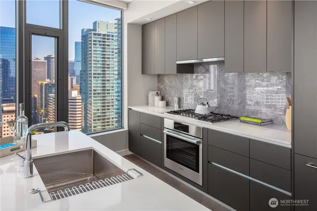 a kitchen with a table chairs refrigerator and cabinets