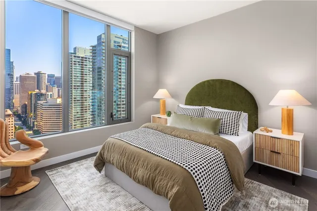 a bedroom with a bed and a large window