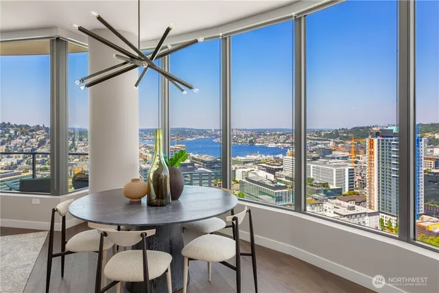 a living room with furniture a rug and a floor to ceiling window
